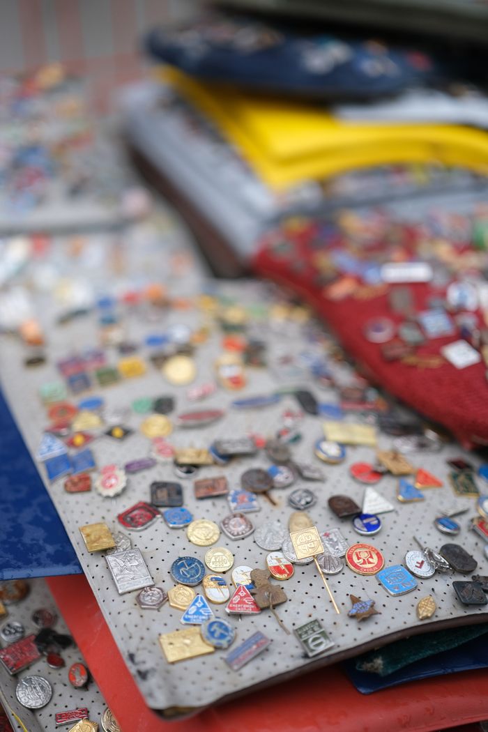 Vibrant collection of vintage pins and badges on display at an outdoor market.